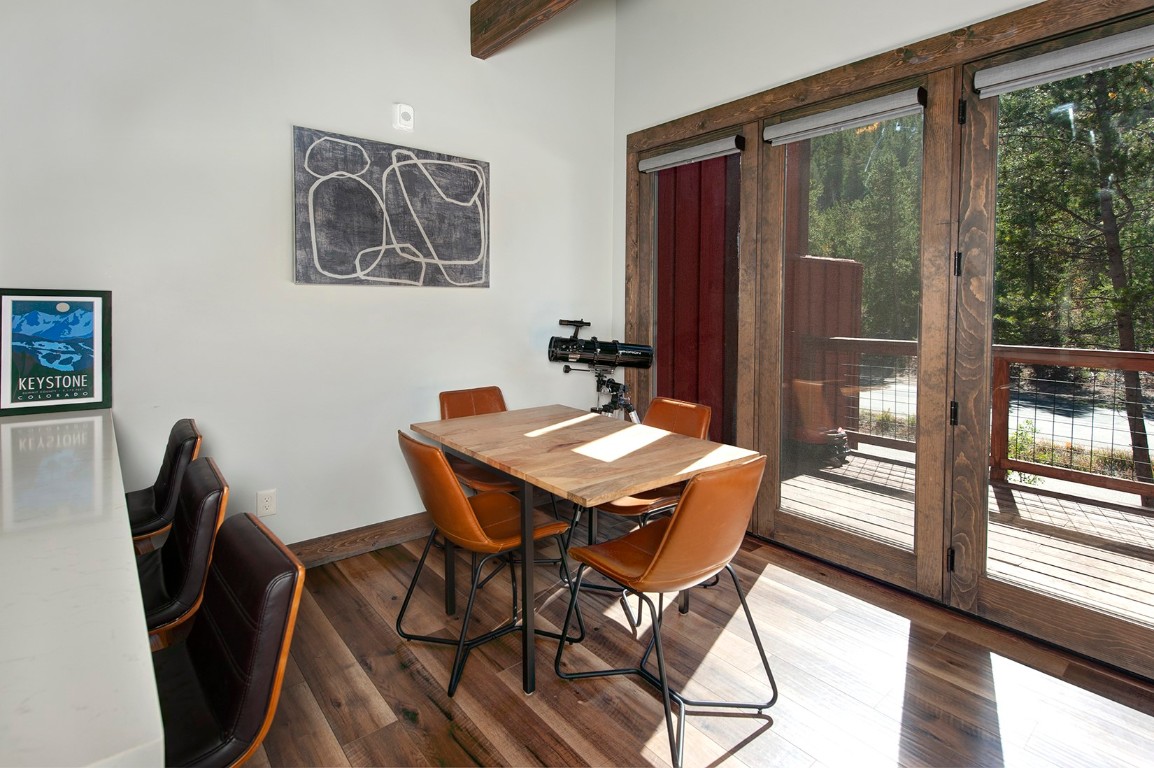 102 Lake Ridge Circle, Unit 1891 Keystone, CO 80435 - Photo 7 of 34 a view of a dining room with furniture wooden floor and a floor to ceiling window
