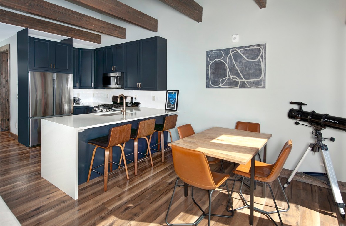 102 Lake Ridge Circle, Unit 1891 Keystone, CO 80435 - Photo 8 of 34 a kitchen with a dining table chairs and refrigerator