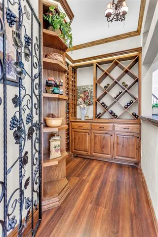 a view of a room with wooden floor and furniture