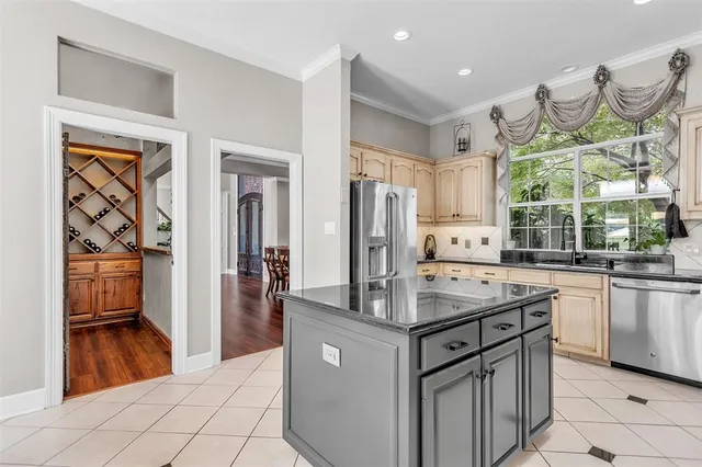 a kitchen with stainless steel appliances granite countertop a sink and a refrigerator