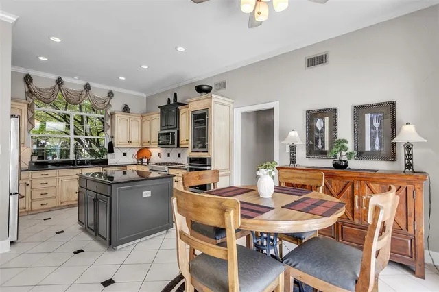 a large kitchen with kitchen island a table and chairs in it