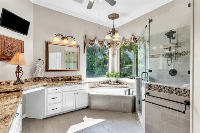 a bathroom with a tub a sink and a mirror