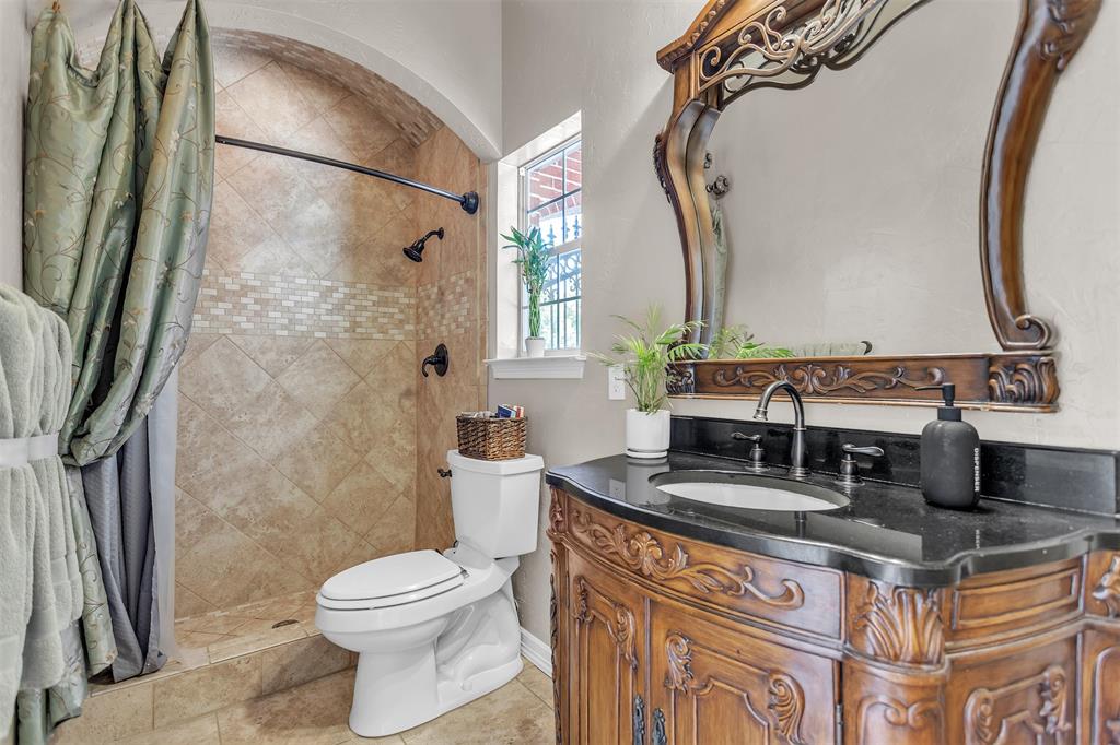 1 Darr Road Heath, TX 75032 - Photo 21 of 38 a bathroom with a granite countertop sink a toilet and shower