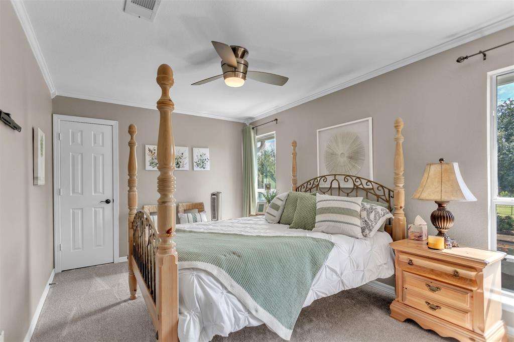 1 Darr Road Heath, TX 75032 - Photo 26 of 38 a bedroom with a bed and a chandelier