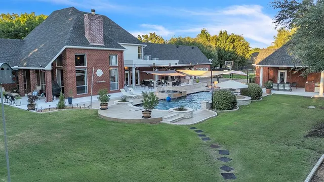 a front view of a house with garden and sitting area
