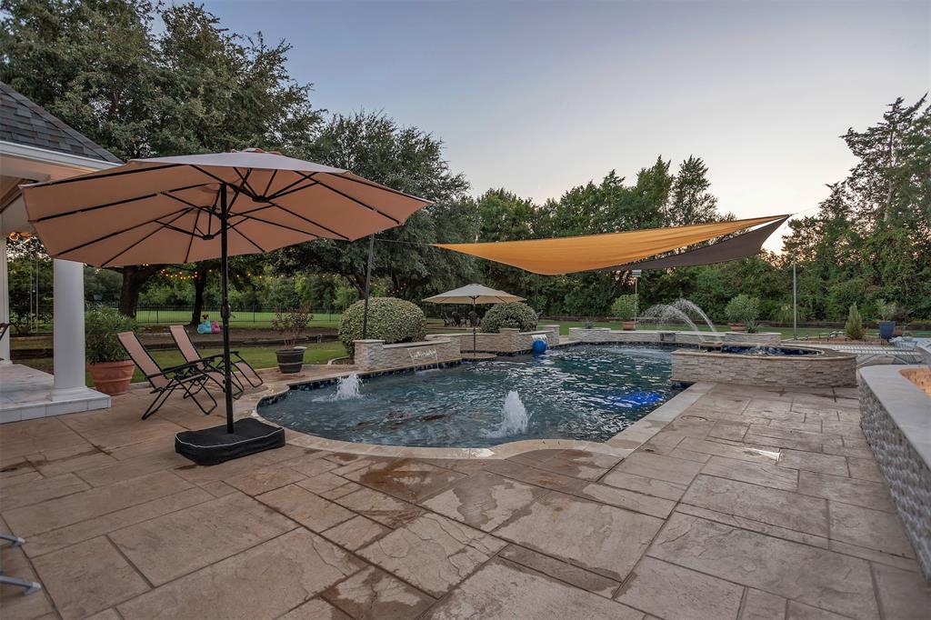 1 Darr Road Heath, TX 75032 - Photo 32 of 38 a view of a patio with a table and chairs under an umbrella