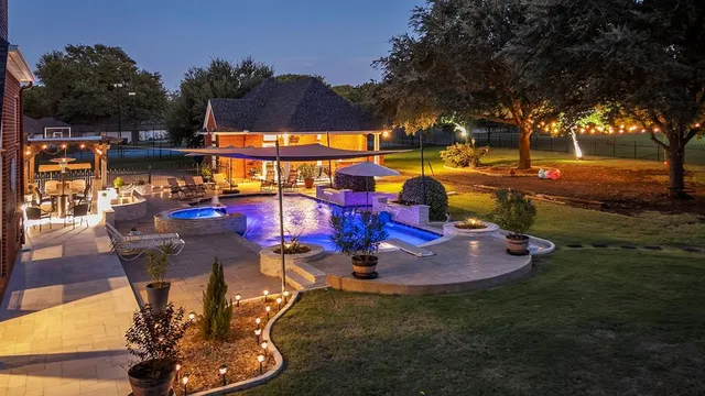 a view of a swimming pool with sitting area