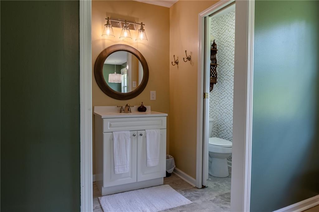 6938 Story Mill Road Hephzibah, GA 30815 - Photo 34 of 36 a bathroom with a sink a mirror and a toilet