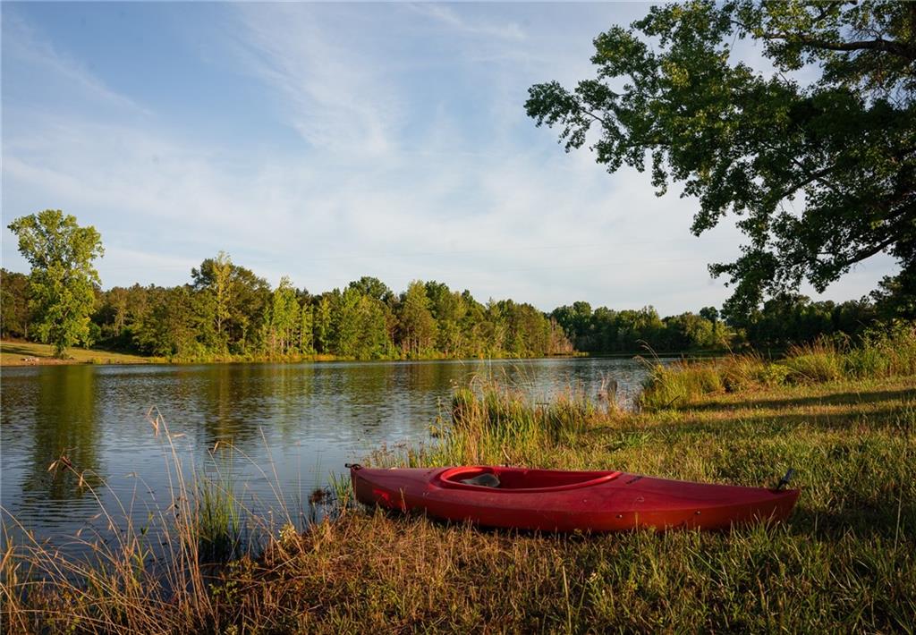 6938 Story Mill Road Hephzibah, GA 30815 - Photo 8 of 36 a view of a lake with a yard