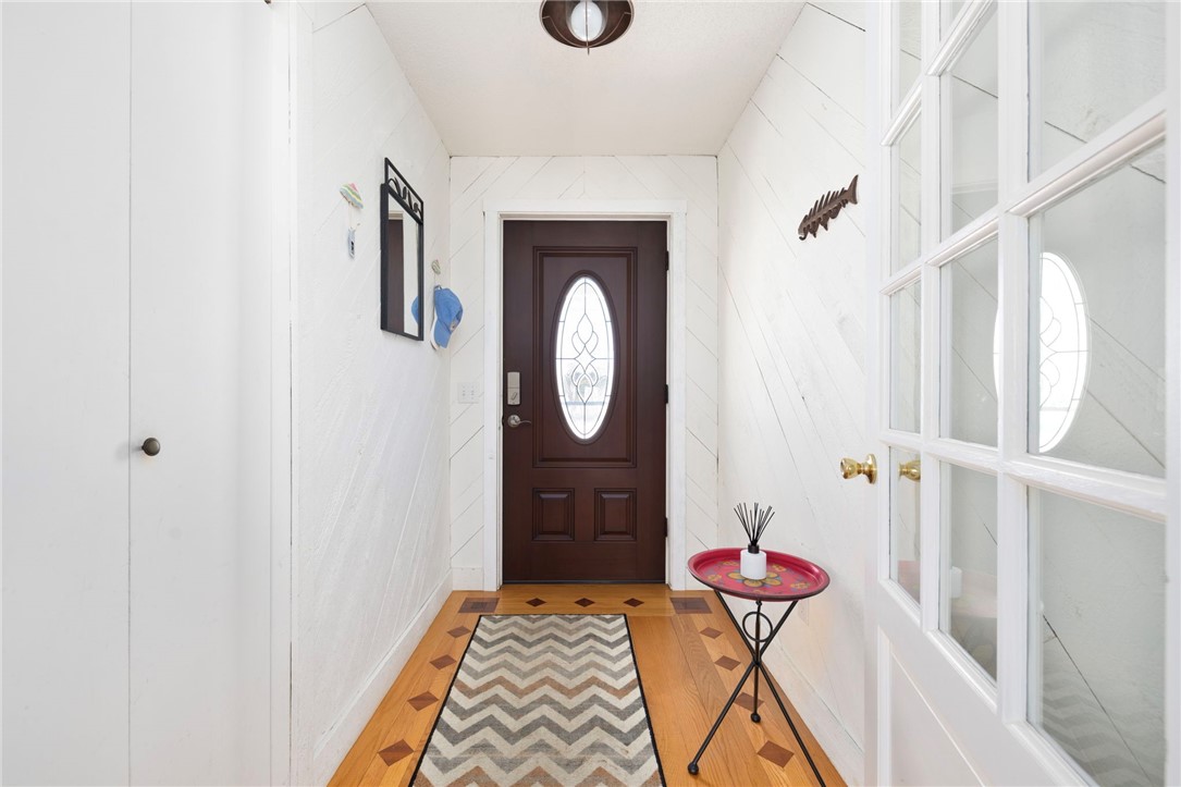 62 Flintstone Road Narragansett, RI 02882 - Photo 11 of 43 A welcomig front entry with striking inlaid oak floors, convenient coat closet and a charming French door into living space.