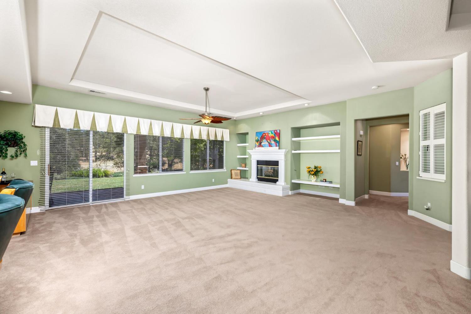 8 Rock Ridge Court, Unit 288 Copperopolis, CA 95228 - Photo 12 of 58 Large open great room with built in shelving, gas fireplace, and sliding doors to the patio.