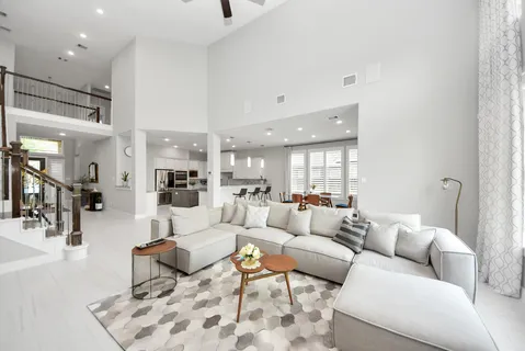 a living room with furniture and a large mirror