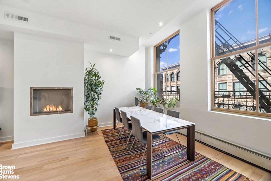 461 Broome Street, Unit 4 Manhattan, NY 10013 - Photo 3 of 14 a workspace with furniture window and wooden floor