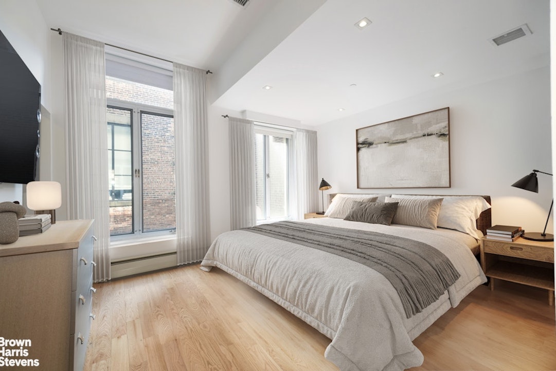 461 Broome Street, Unit 4 Manhattan, NY 10013 - Photo 4 of 14 a spacious bedroom with a bed and a large window