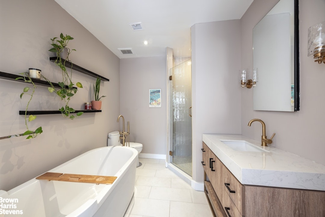 461 Broome Street, Unit 4 Manhattan, NY 10013 - Photo 5 of 14 a bathroom with a double vanity sink and mirror