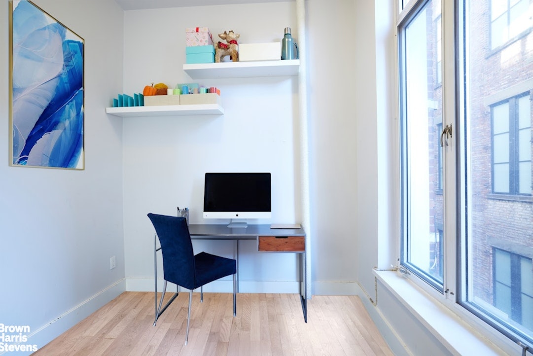 461 Broome Street, Unit 4 Manhattan, NY 10013 - Photo 8 of 14 a workspace with furniture and wooden floor