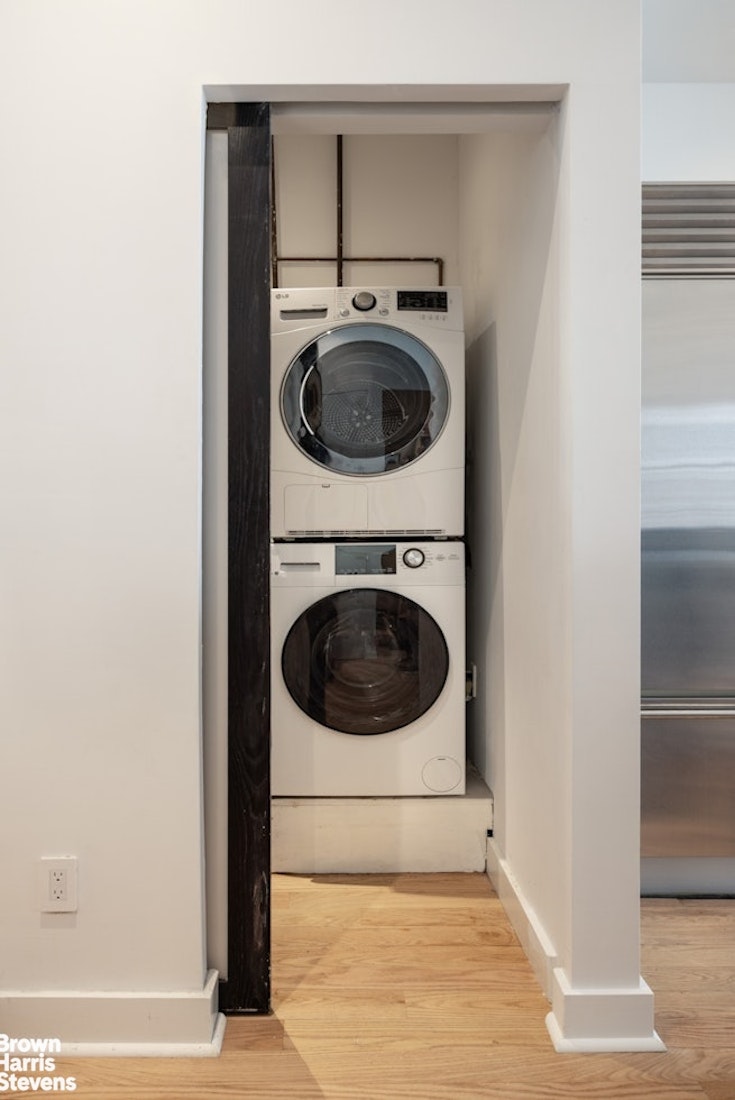 461 Broome Street, Unit 4 Manhattan, NY 10013 - Photo 9 of 14 a utility room with dryer and washer