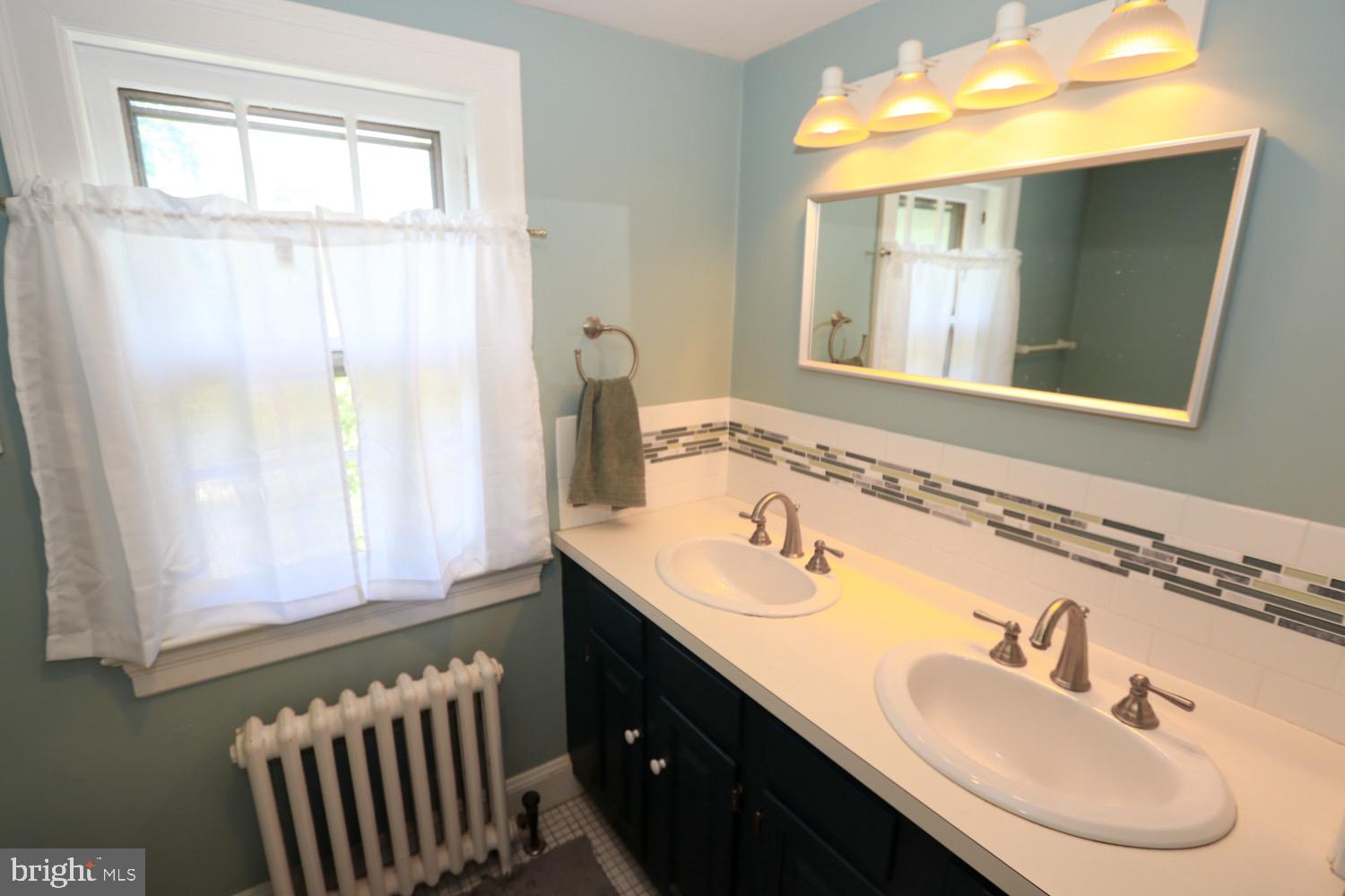 2701 Alden Road Bryn Athyn, PA 19006 - Photo 58 of 105 a bathroom with a sink and a mirror