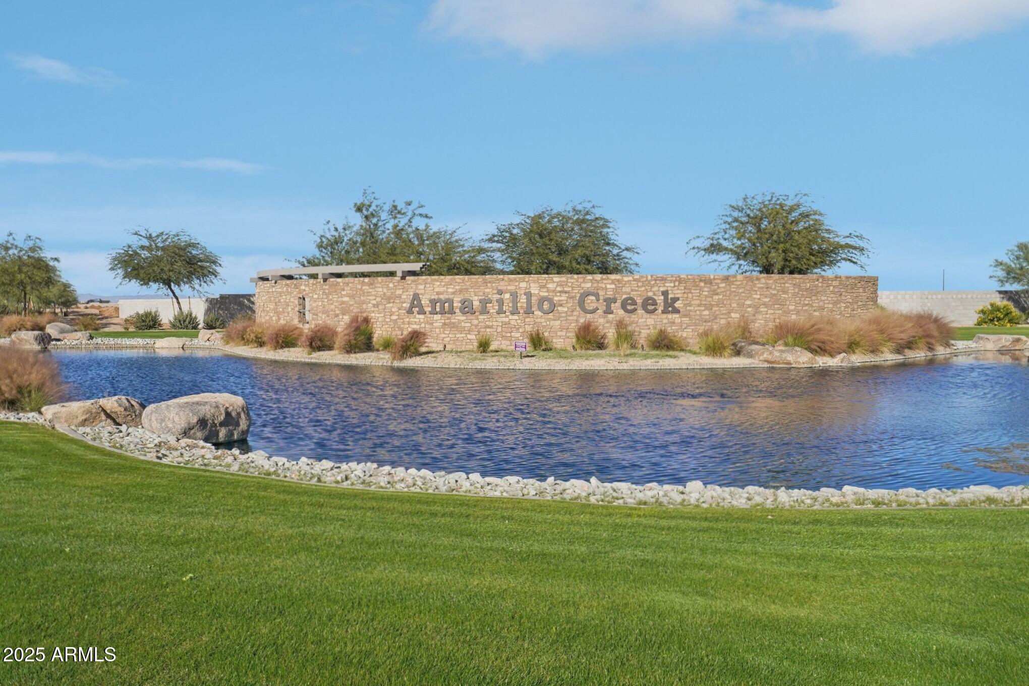 47454 West Old Timer Road Maricopa, AZ 85139 - Photo 4 of 23 a view of a lake with lawn chairs and large trees