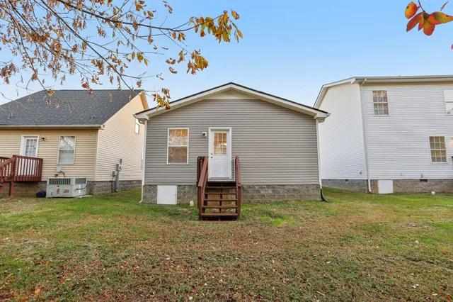 a backyard of a house with table and chairs