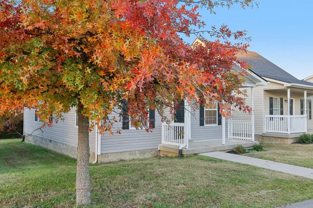 a front view of a house with a garden