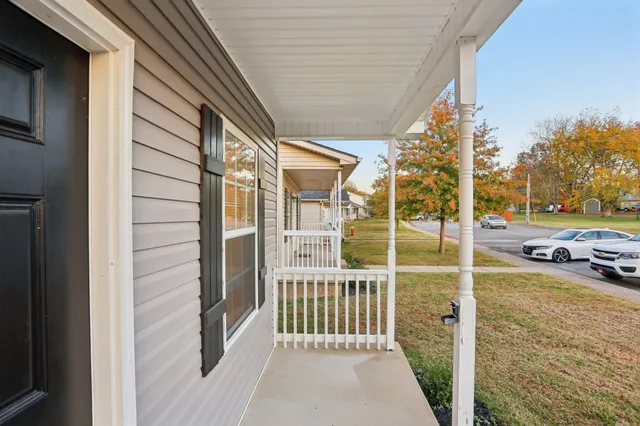 a view of a porch with a floor to ceiling window and tree