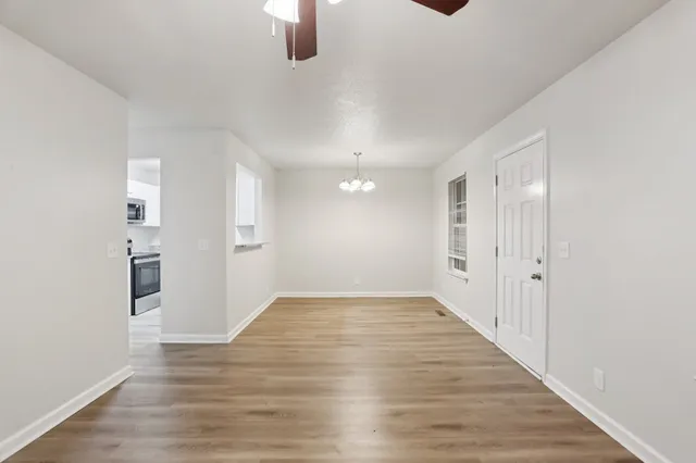 a view of an empty room and wooden floor