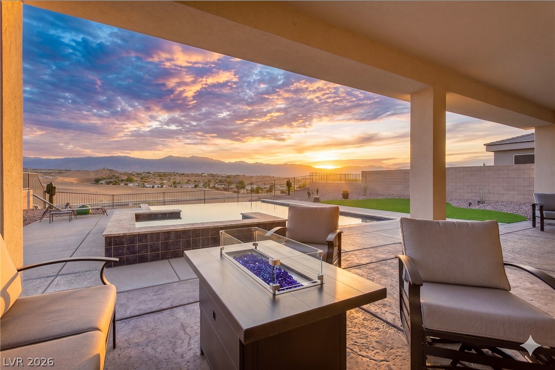 1460 Blue Ridge Trail Mesquite, NV 89027 - Photo 2 of 39 Experience golden hour over the mountains from a covered patio with a serene pool.
