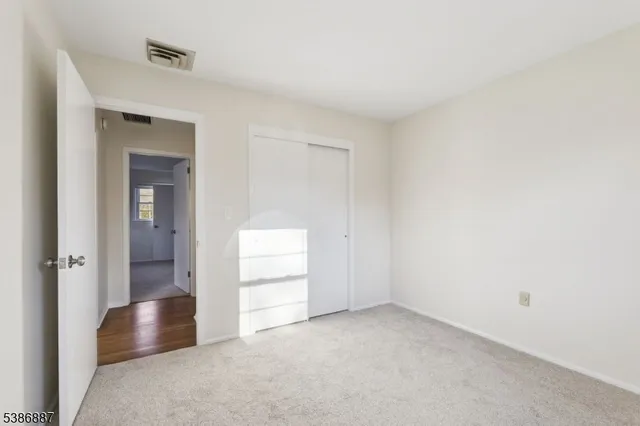 a bathroom with a granite countertop sink a large mirror and a bathtub