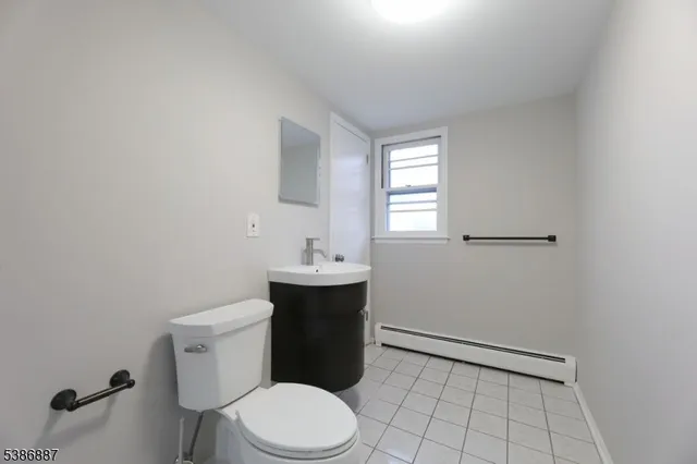 a bathroom with a sink a toilet and window