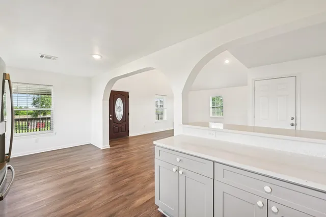 a view of a room with wooden floor and window