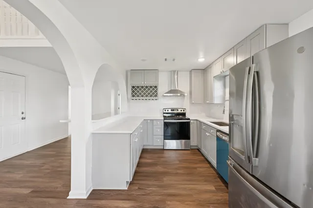 a kitchen with a refrigerator a sink and dishwasher