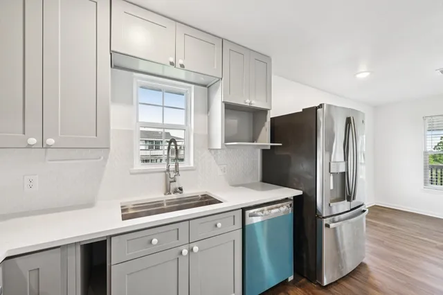 a kitchen with stainless steel appliances a refrigerator sink and cabinets