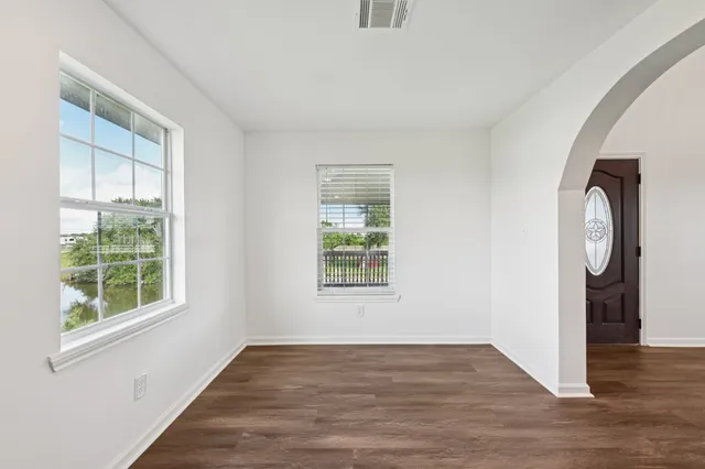 wooden floor in an empty room with a window