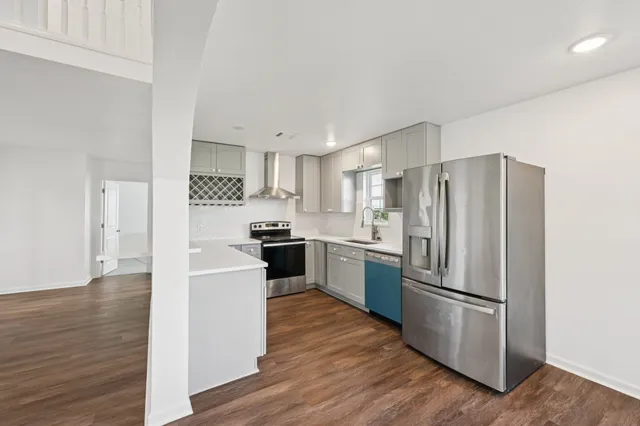 a kitchen with a refrigerator and a sink