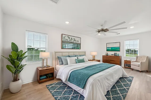 a bedroom with a balcony a bed and a potted plant