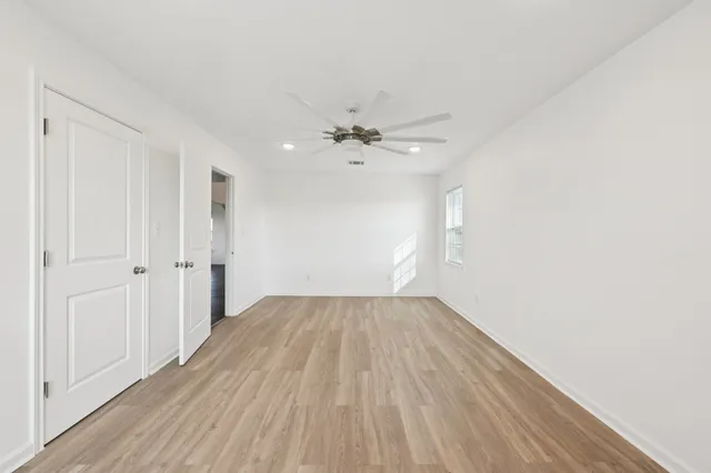 wooden floor in an empty room with a window