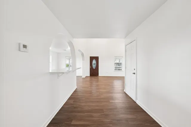 a view of a hallway with wooden floor