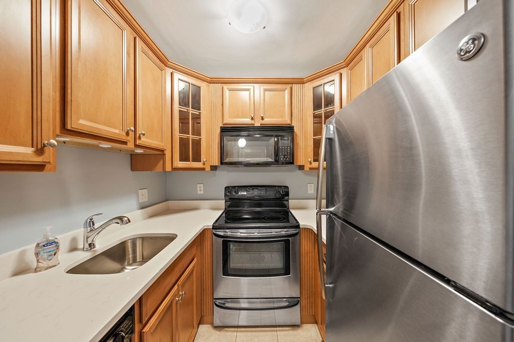217 Neponset Avenue, Unit 33 Boston, MA 02122 - Photo 5 of 12 a kitchen with a refrigerator and a sink
