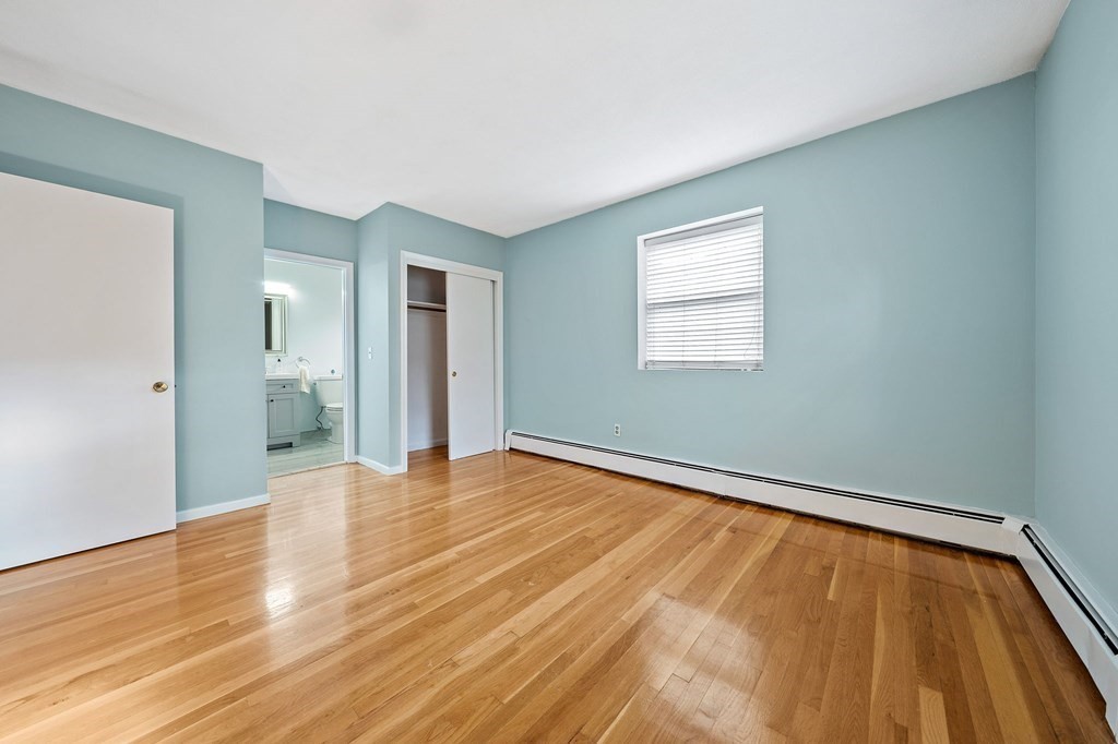 217 Neponset Avenue, Unit 33 Boston, MA 02122 - Photo 7 of 12 a view of an empty room with wooden floor and a window