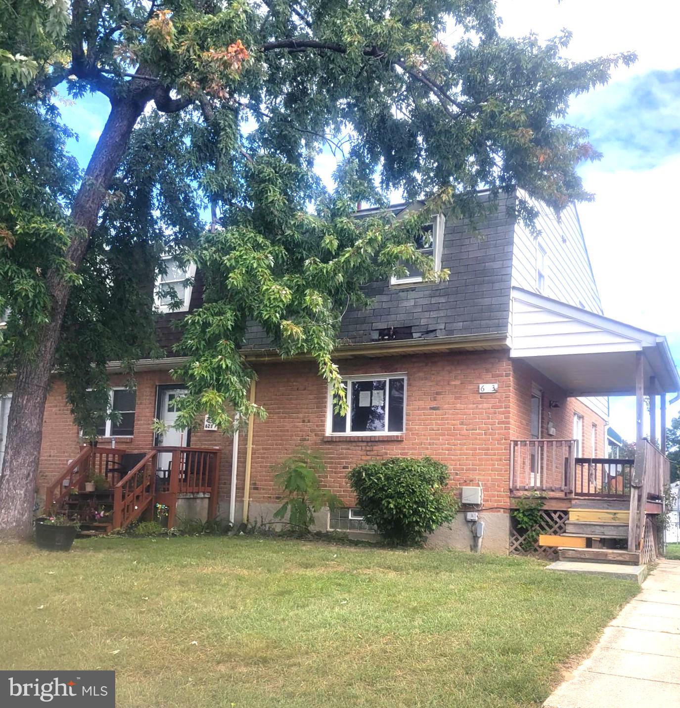 a view of a house with a yard porch and sitting area