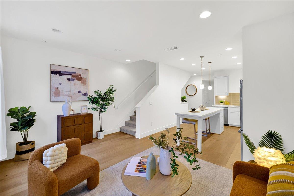 a living room with furniture and a potted plant