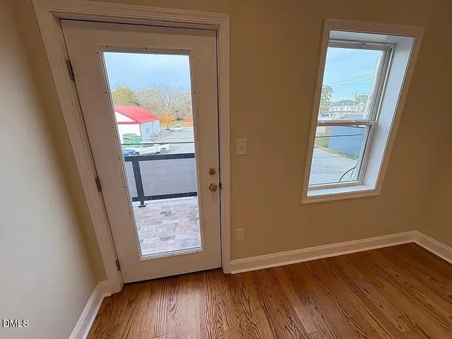 a view of an entryway with wooden floor