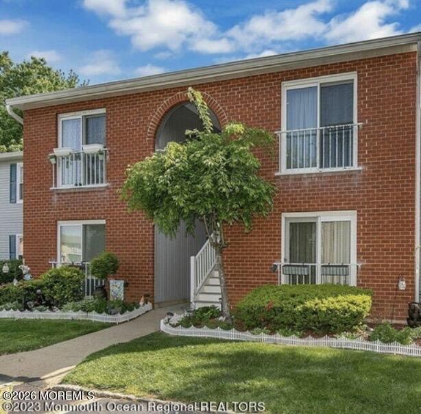 505 Harding Road, Unit 4 Freehold, NJ 07728 - Photo 1 of 9 a front view of a house with a garden and plants