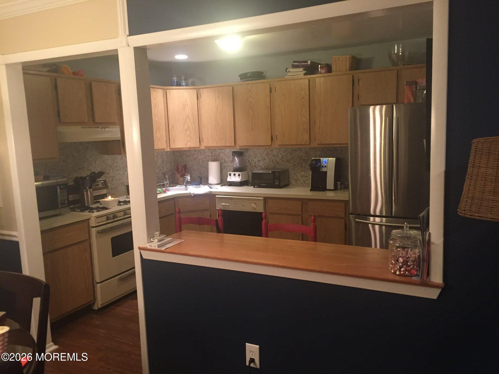 505 Harding Road, Unit 4 Freehold, NJ 07728 - Photo 2 of 9 a kitchen with stainless steel appliances a sink stove and refrigerator