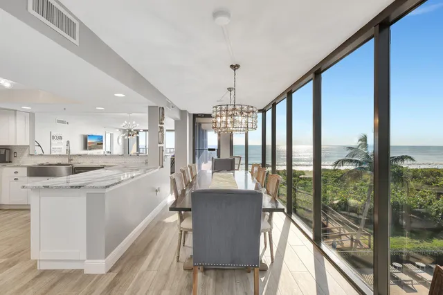 a view of a kitchen with kitchen island granite countertop a large window