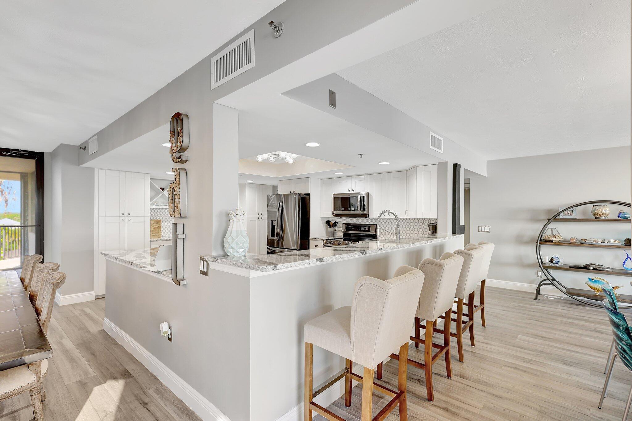 4000 North Hwy A1A, Unit 402 Hutchinson Island, FL 34949 - Photo 11 of 60 a view of a dining room with furniture and wooden floor