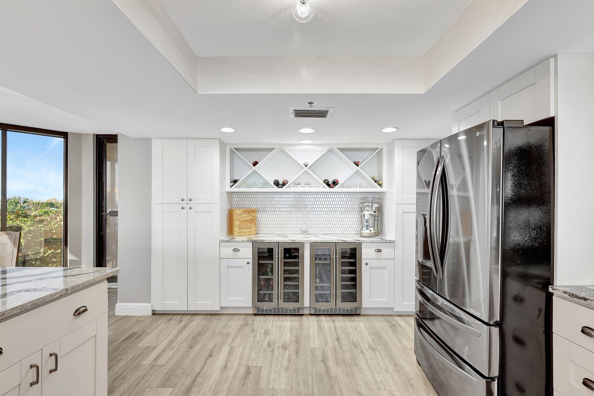 4000 North Hwy A1A, Unit 402 Hutchinson Island, FL 34949 - Photo 17 of 60 a kitchen with stainless steel appliances granite countertop a refrigerator and a stove top oven