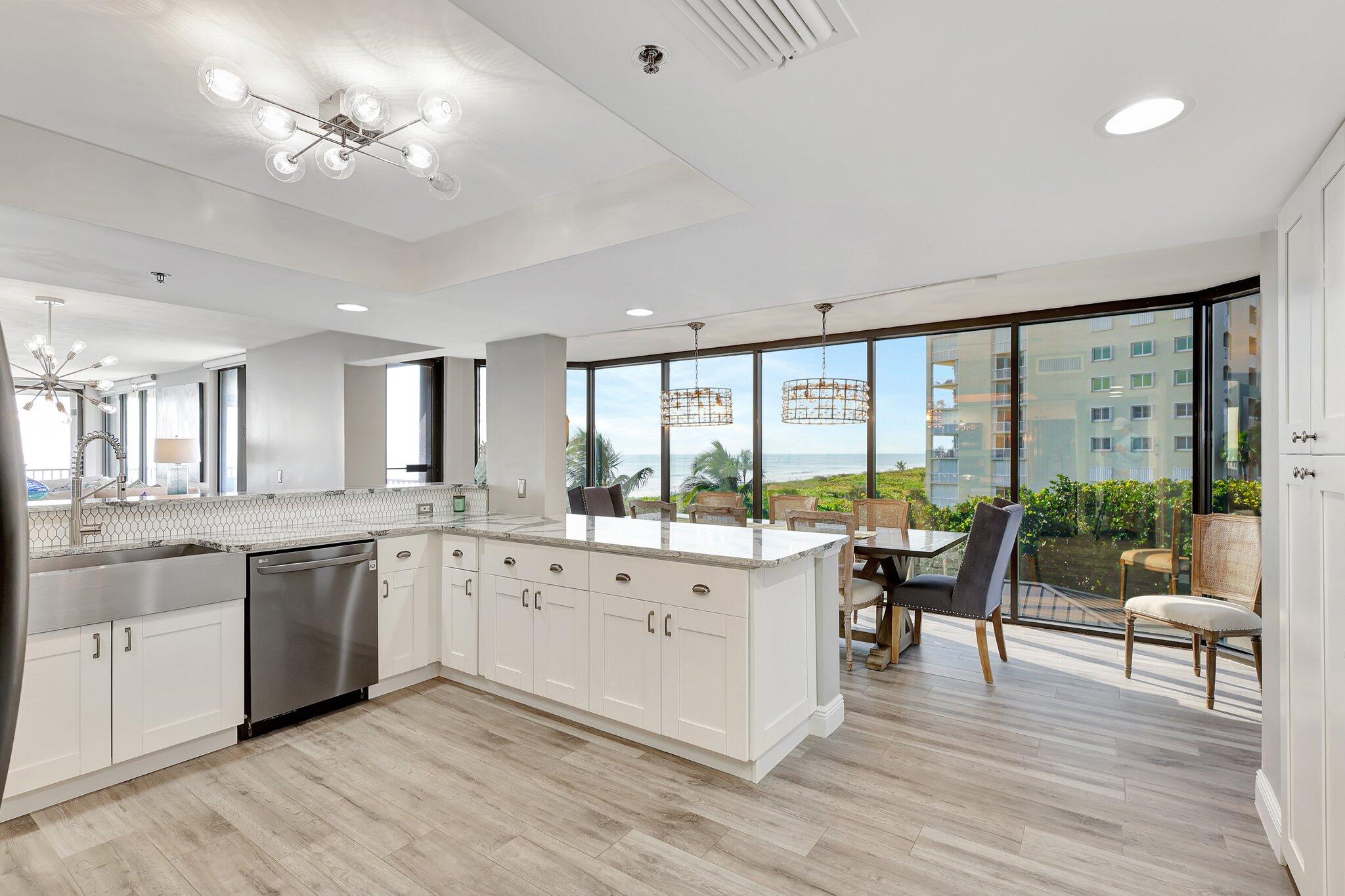 4000 North Hwy A1A, Unit 402 Hutchinson Island, FL 34949 - Photo 19 of 60 a large white kitchen with a large window