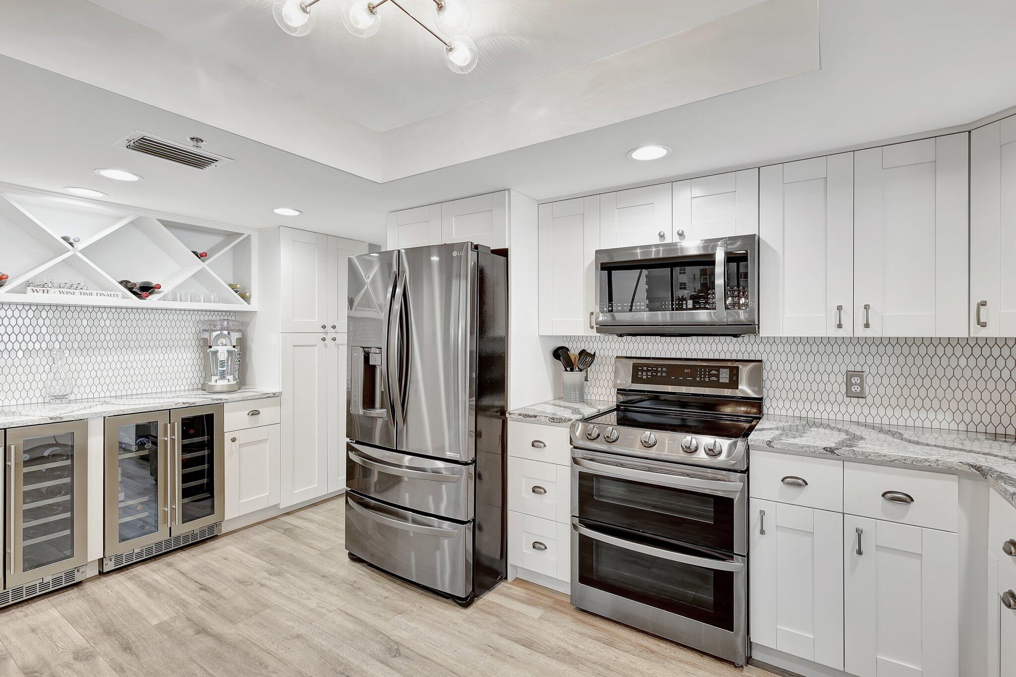 4000 North Hwy A1A, Unit 402 Hutchinson Island, FL 34949 - Photo 20 of 60 a kitchen with a refrigerator stove and oven